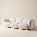 Kremowa sofa trzyosobowa z tkaniny bouclé, 230 × 100 × 75 cm, zaokrąglona forma